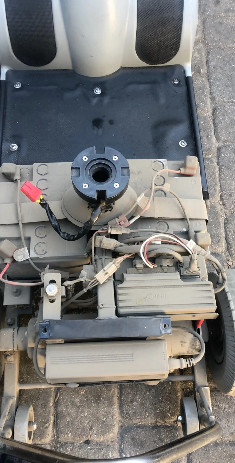 Mobility equipment with its cover removed and wiring exposed.