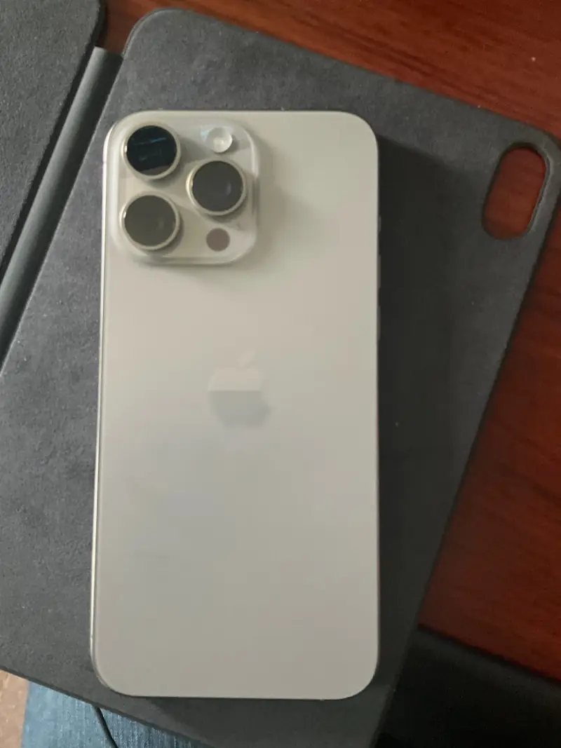 iPhone 15 Pro Max in Natural Titanium.