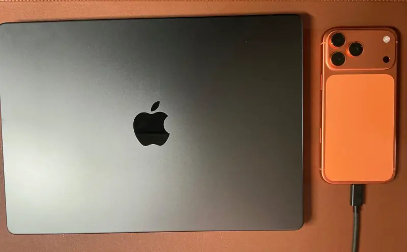 MacBook and orange iPhone.