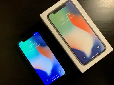 iPhone X beside its box.