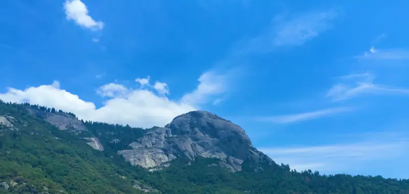 Mountain peaks beneath a bright blue sky.